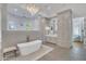 Elegant bathroom with soaking tub, walk-in shower, and ample cabinetry at 20445 E Sunset Ct, Queen Creek, AZ 85142