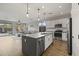 Modern kitchen with large island, white cabinets, and stainless steel appliances at 41448 N Bent Creek Way, Phoenix, AZ 85086