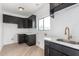 Laundry room with dark cabinets, quartz countertops, and a stylish faucet at 6035 E Monterra Way, Scottsdale, AZ 85262