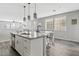 Open concept kitchen with large island and white shaker cabinets at 1675 E Bridgeport Pkwy, Gilbert, AZ 85295