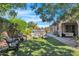 Peaceful backyard with two wicker chairs, lush grass, and pool view at 3424 E Plum St, Gilbert, AZ 85298