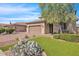 Two-story home with tan exterior, landscaping, and a three-car garage at 3424 E Plum St, Gilbert, AZ 85298