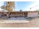 View of home's back and covered patio, plus a yard at 3816 W Thomas Rd, Phoenix, AZ 85019