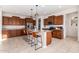 Modern kitchen with island, stainless steel appliances, and wood cabinets at 23095 E Mewes Rd, Queen Creek, AZ 85142
