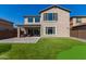 Two-story home with backyard patio, putting green, and artificial turf at 23095 E Mewes Rd, Queen Creek, AZ 85142
