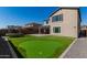 Spacious backyard with putting green, trampoline, and home view at 23095 E Mewes Rd, Queen Creek, AZ 85142