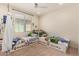 Spacious bedroom with twin beds, window, and playful decor at 23095 E Mewes Rd, Queen Creek, AZ 85142