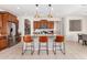 Modern kitchen with island, stainless steel appliances, and wood cabinets at 23095 E Mewes Rd, Queen Creek, AZ 85142