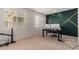 Home office with a desk, two monitors, and a green accent wall at 23095 E Mewes Rd, Queen Creek, AZ 85142