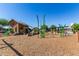 Community playground with playset and wood chips at 23095 E Mewes Rd, Queen Creek, AZ 85142