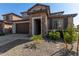 Two-story house with stone accents and a brown door at 23095 E Mewes Rd, Queen Creek, AZ 85142