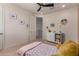 Charming bedroom featuring a twin bed, ceiling fan, and decorative wall art at 23095 E Mewes Rd, Queen Creek, AZ 85142