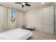 Well-lit bedroom with window and ceiling fan at 23095 E Mewes Rd, Queen Creek, AZ 85142
