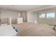 Spacious loft area with large windows and carpeted floor at 23095 E Mewes Rd, Queen Creek, AZ 85142