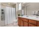 Bathroom with tub, shower and wood vanity at 23095 E Mewes Rd, Queen Creek, AZ 85142