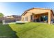 Expansive backyard with a sparkling pool and artificial turf at 17523 W Fetlock Trl, Surprise, AZ 85387
