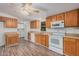 Modern kitchen with oak cabinets and white appliances at 2650 W Union Hills Dr # 54, Phoenix, AZ 85027