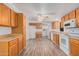 Clean kitchen with oak cabinets, white appliances, and laminate floors at 2650 W Union Hills Dr # 54, Phoenix, AZ 85027