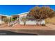Mobile home with ramp access, mature trees, and a paved driveway at 2650 W Union Hills Dr # 54, Phoenix, AZ 85027