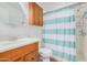 Bathroom with single sink, wood cabinet, and shower at 2650 W Union Hills Dr # 54, Phoenix, AZ 85027