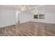 Spacious living room featuring laminate wood flooring and ceiling fans at 2650 W Union Hills Dr # 54, Phoenix, AZ 85027