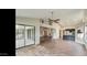 Bright and airy living area with tile floors and a view of the kitchen and patio at 13035 W Ballad W Dr, Sun City West, AZ 85375