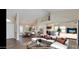 Open-concept living area with hardwood floors, stylish furniture, and access to kitchen at 13035 W Ballad W Dr, Sun City West, AZ 85375