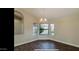 Bright dining room with wood floors and a large window at 13035 W Ballad W Dr, Sun City West, AZ 85375