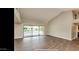 Spacious living room with tile floors and sliding glass doors to patio at 13035 W Ballad W Dr, Sun City West, AZ 85375