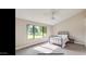 Comfortable bedroom with a metal bed frame, dresser, and large windows at 13035 W Ballad W Dr, Sun City West, AZ 85375