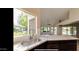 Kitchen features granite counters, a stylish sink, and views of the backyard at 13035 W Ballad W Dr, Sun City West, AZ 85375