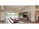 Living room with tiled floors, a flat-screen TV, and access to a backyard at 13035 W Ballad W Dr, Sun City West, AZ 85375