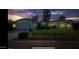 Single-story home with a well-maintained lawn, illuminated at night at 13035 W Ballad W Dr, Sun City West, AZ 85375