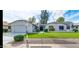 Single-story home with a well-maintained lawn and attractive landscaping at 13035 W Ballad W Dr, Sun City West, AZ 85375
