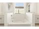 Modern bathroom with double sinks and a large soaking tub at 4658 N 177Th Dr, Goodyear, AZ 85395