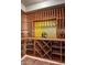 Built-in wine cellar with wood racks and yellow accent wall at 42820 N Fleming Springs Rd, Cave Creek, AZ 85331