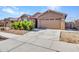 Single-story home with two-car garage and landscaped front yard at 24614 N 169Th Dr, Surprise, AZ 85387