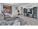 Spacious living area featuring a large TV, comfortable seating, and access to the backyard at 24614 N 169Th Dr, Surprise, AZ 85387