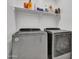 Laundry room with washer, dryer, and shelving for storage at 24614 N 169Th Dr, Surprise, AZ 85387