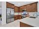 Modern kitchen with stainless steel appliances and wood cabinets at 24614 N 169Th Dr, Surprise, AZ 85387