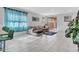 Bright living room with tile floors, comfy sectional sofa, and sliding glass door to backyard at 24614 N 169Th Dr, Surprise, AZ 85387