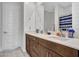 Bathroom with double vanity, dark brown cabinets and a shower/tub combo at 24614 N 169Th Dr, Surprise, AZ 85387