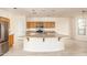 Modern kitchen with a large curved island and stainless steel appliances at 1384 E Morelos St, Chandler, AZ 85225
