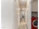 Clean hallway with light wood flooring and a red LG washer and dryer at 1384 E Morelos St, Chandler, AZ 85225