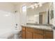 Clean bathroom with granite countertop, wood cabinets, and shower at 1384 E Morelos St, Chandler, AZ 85225