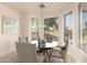 Bright dining area with a glass table and four chairs, offering ample natural light at 1384 E Morelos St, Chandler, AZ 85225