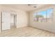 Well-lit bedroom with wood flooring and access to another room at 1384 E Morelos St, Chandler, AZ 85225