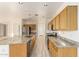 Modern kitchen with a large island, stainless steel appliances, and light wood cabinets at 1384 E Morelos St, Chandler, AZ 85225