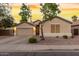 Single-story house with a two-car garage and landscaped front yard at 1384 E Morelos St, Chandler, AZ 85225