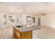 Kitchen island with granite countertops and light wood cabinets at 1384 E Morelos St, Chandler, AZ 85225